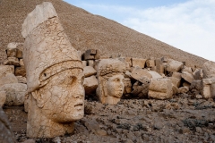 The west terrace of Mount Nemrut with heads of the colossal statues and the tumulus. Head of Antiochos I in foreground with Commagene behind. The UNESCO World Heritage Site at Mount Nemrut where King Antiochus of Commagene is reputedly entombed. (Turkish: Nemrut Dağı)