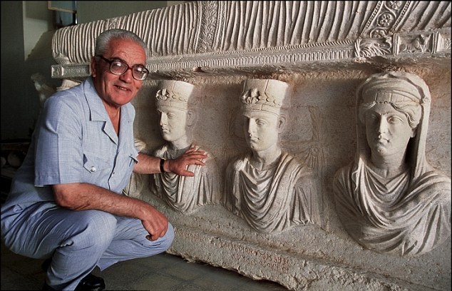Khaled Asaad is pictured in 2002 in front of a sarcophagus from Palmyra, dating back to the first century.