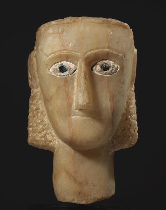 A SOUTH ARABIAN ALABASTER HEAD OF A WHITE MAN WITH BLUE EYES CIRCA 1ST CENTURY B.C.-1ST CENTURY A.D